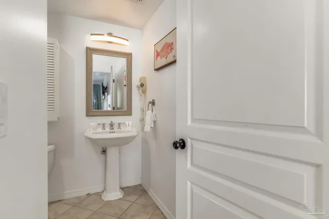 a bathroom with a sink and mirror with toilet