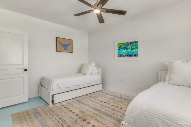 a bedroom with a bed and a painting on the wall