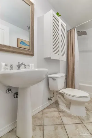 a bathroom with a sink toilet and mirror