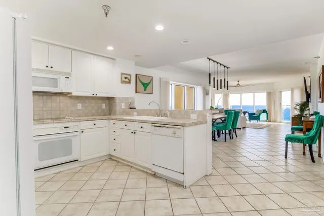 a kitchen with cabinets and chairs