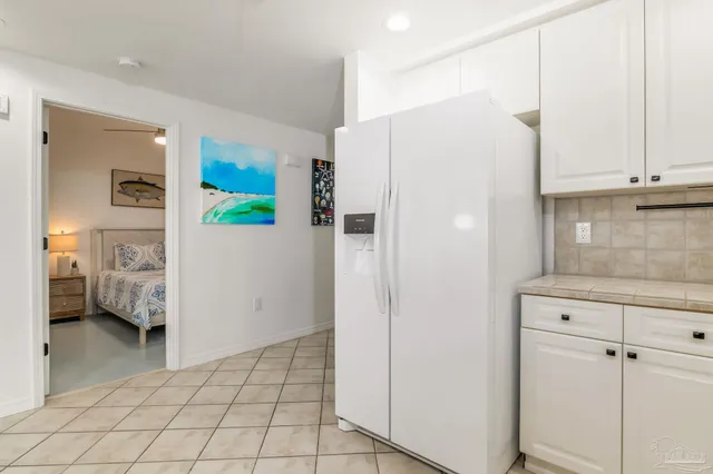 a kitchen with a refrigerator a stove and cabinets