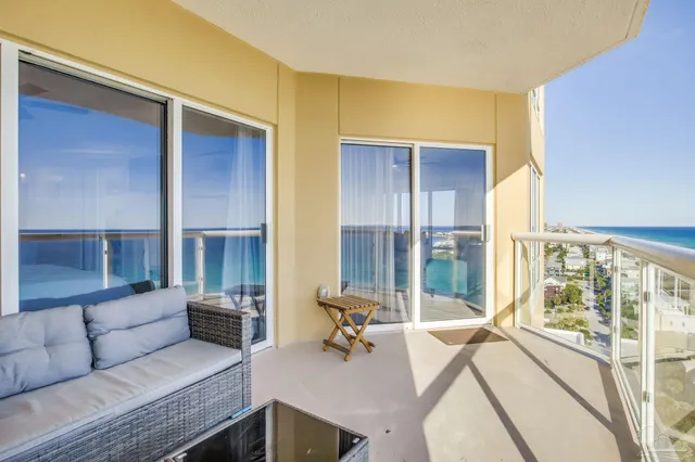 a living room with furniture and large windows
