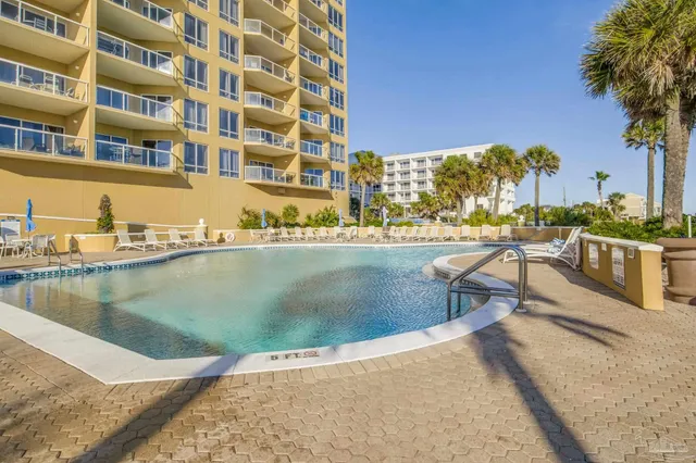 a view of a lake with a building and outdoor seating