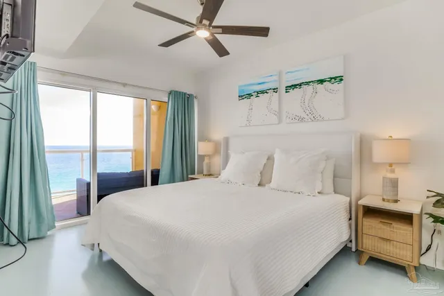 a bedroom with a bed and large window