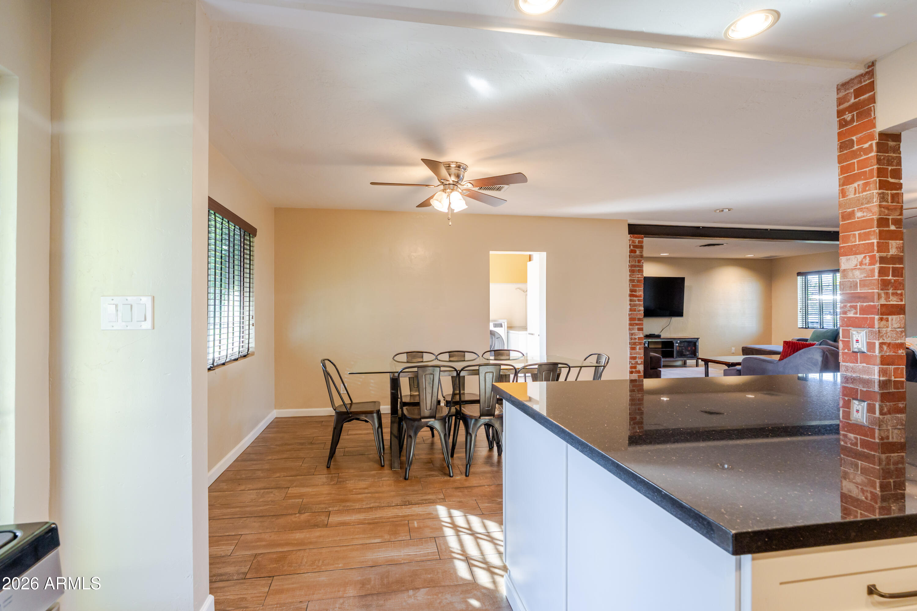 1631 West Rovey Avenue Phoenix, AZ 85015 - Photo 14 of 46 a view of a dining room with furniture and a chandelier