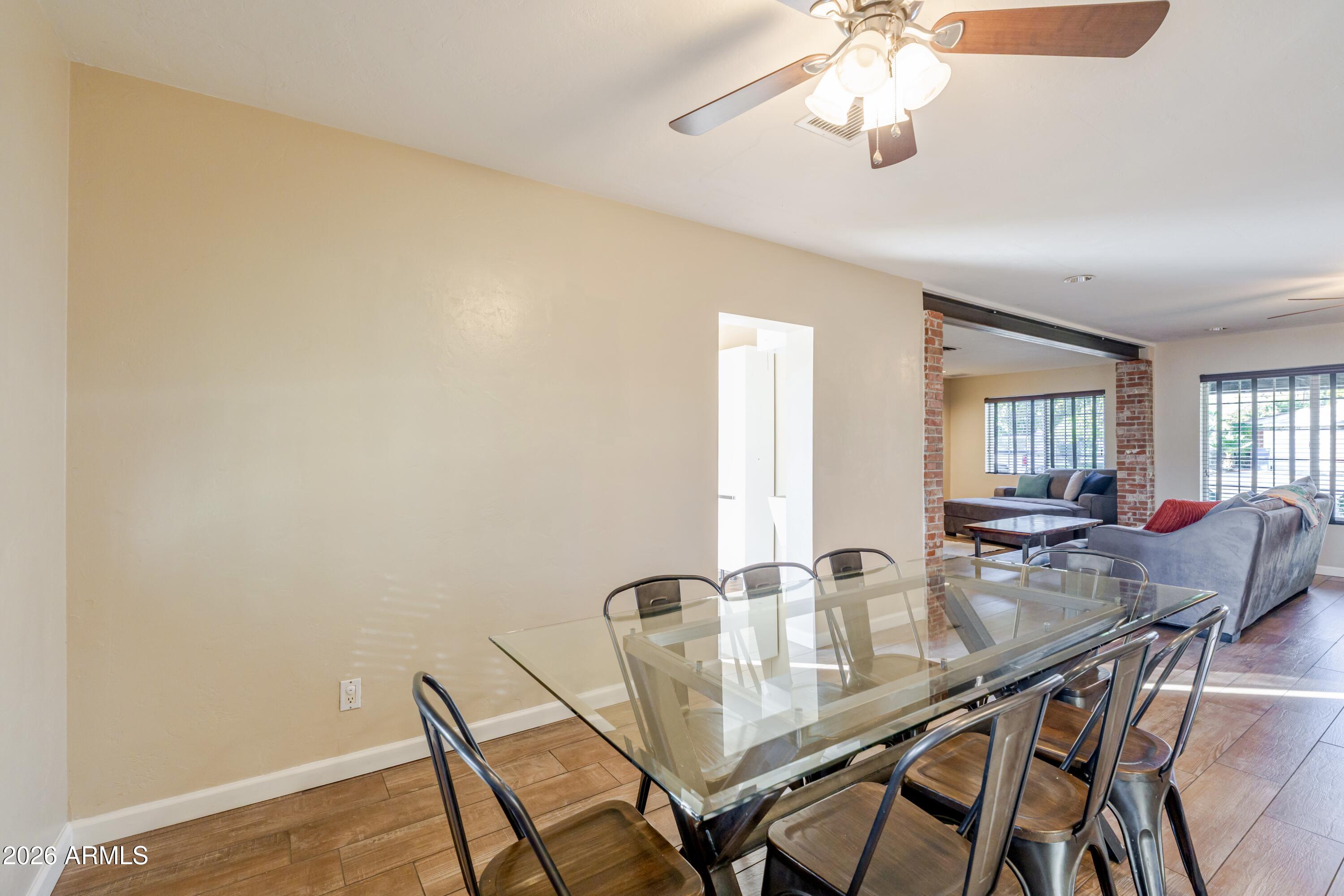 1631 West Rovey Avenue Phoenix, AZ 85015 - Photo 16 of 46 a view of a dining room with furniture and chandelier