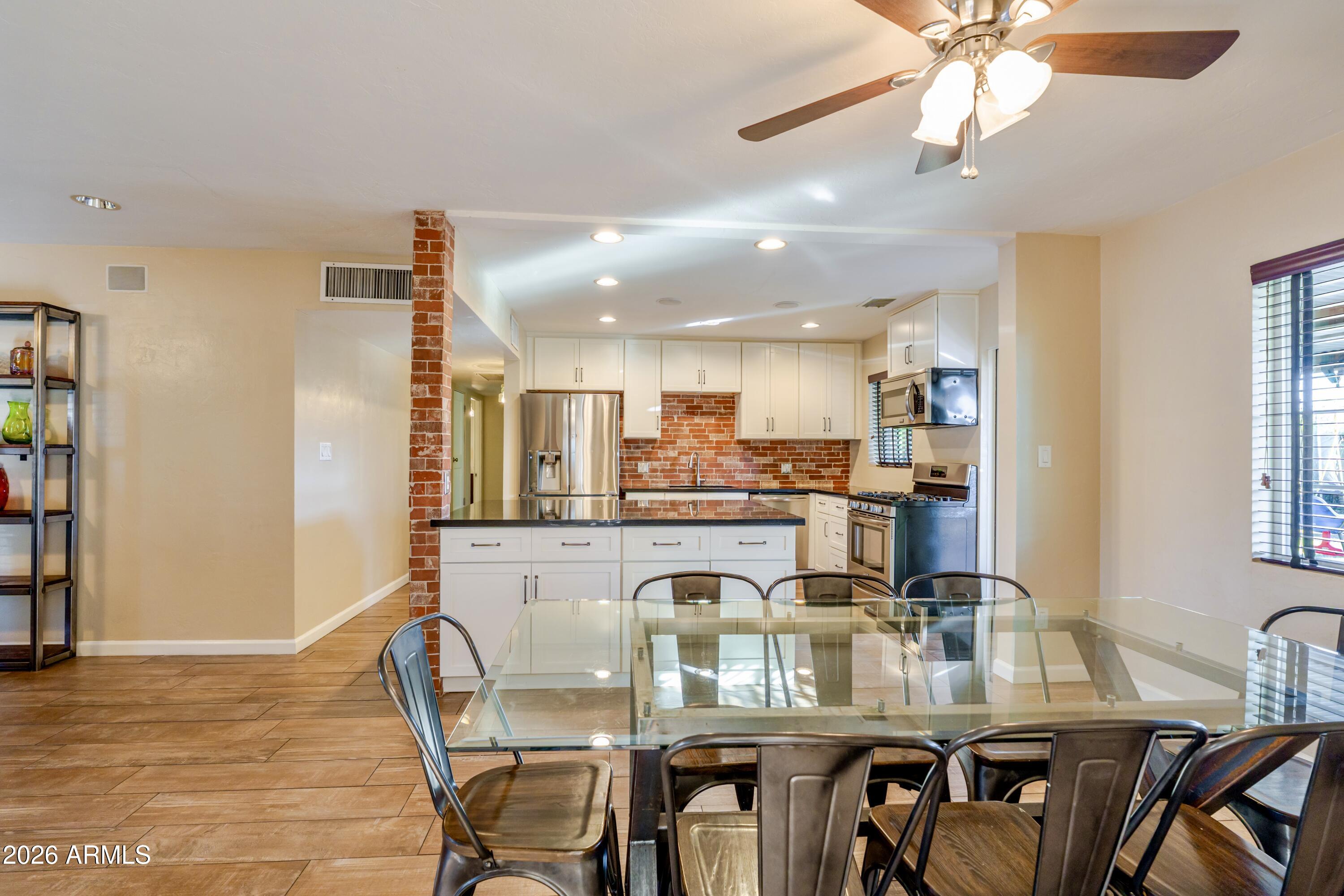 1631 West Rovey Avenue Phoenix, AZ 85015 - Photo 18 of 46 a view of a dining room with furniture and wooden floor