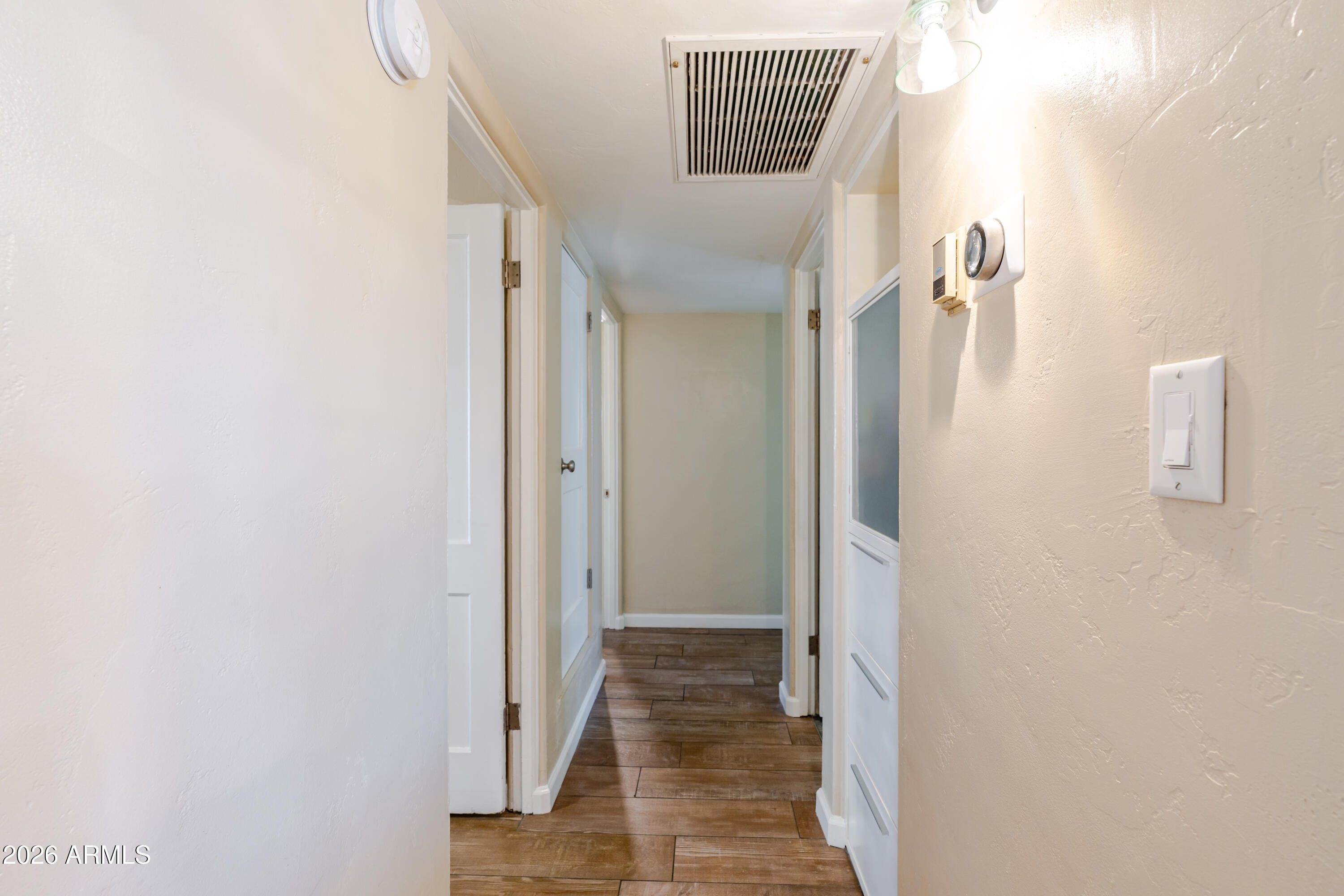 1631 West Rovey Avenue Phoenix, AZ 85015 - Photo 19 of 46 a view of a hallway with wooden floor and entryway