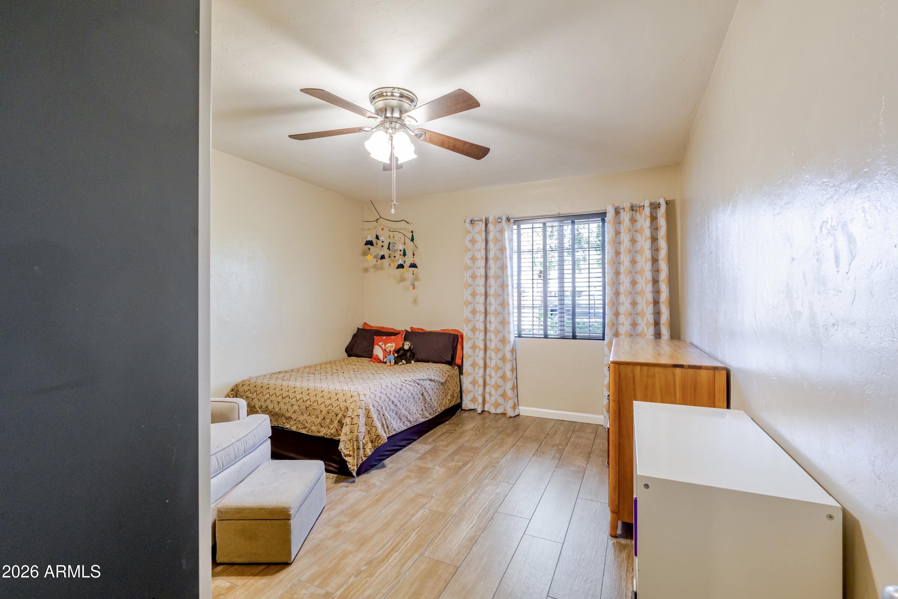 1631 West Rovey Avenue Phoenix, AZ 85015 - Photo 20 of 46 a bedroom with a bed and a chandelier