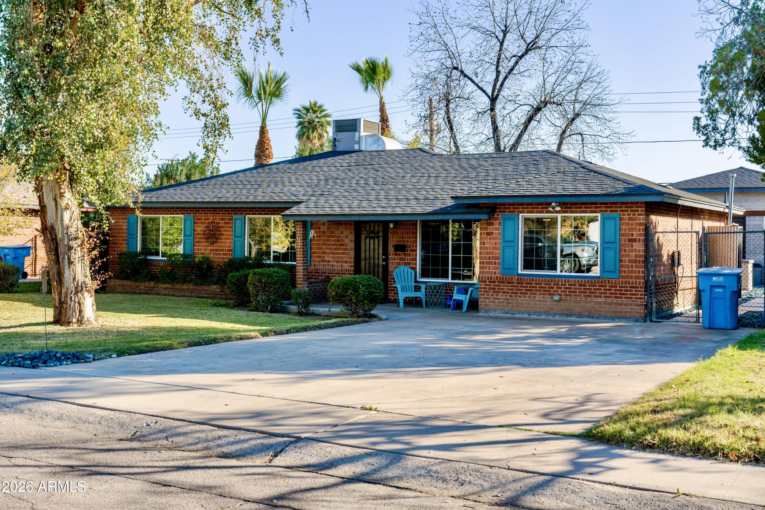 1631 West Rovey Avenue Phoenix, AZ 85015 - Photo 2 of 46 a front view of a house with garden