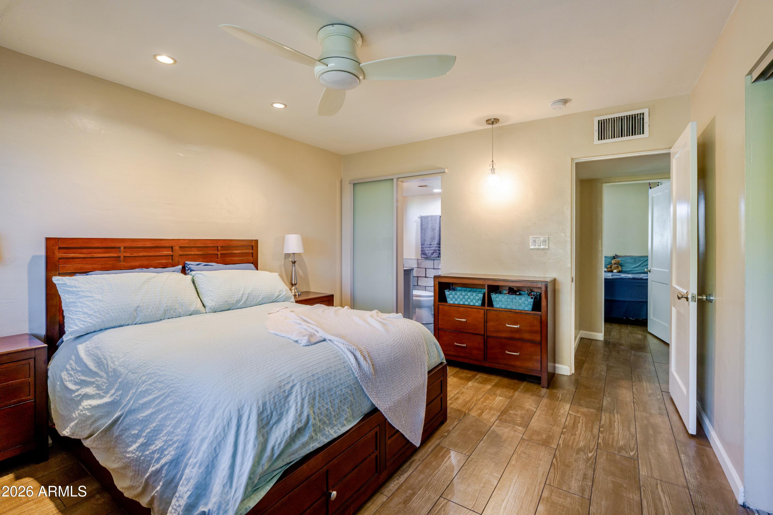 1631 West Rovey Avenue Phoenix, AZ 85015 - Photo 22 of 46 a bedroom with a bed and a chandelier