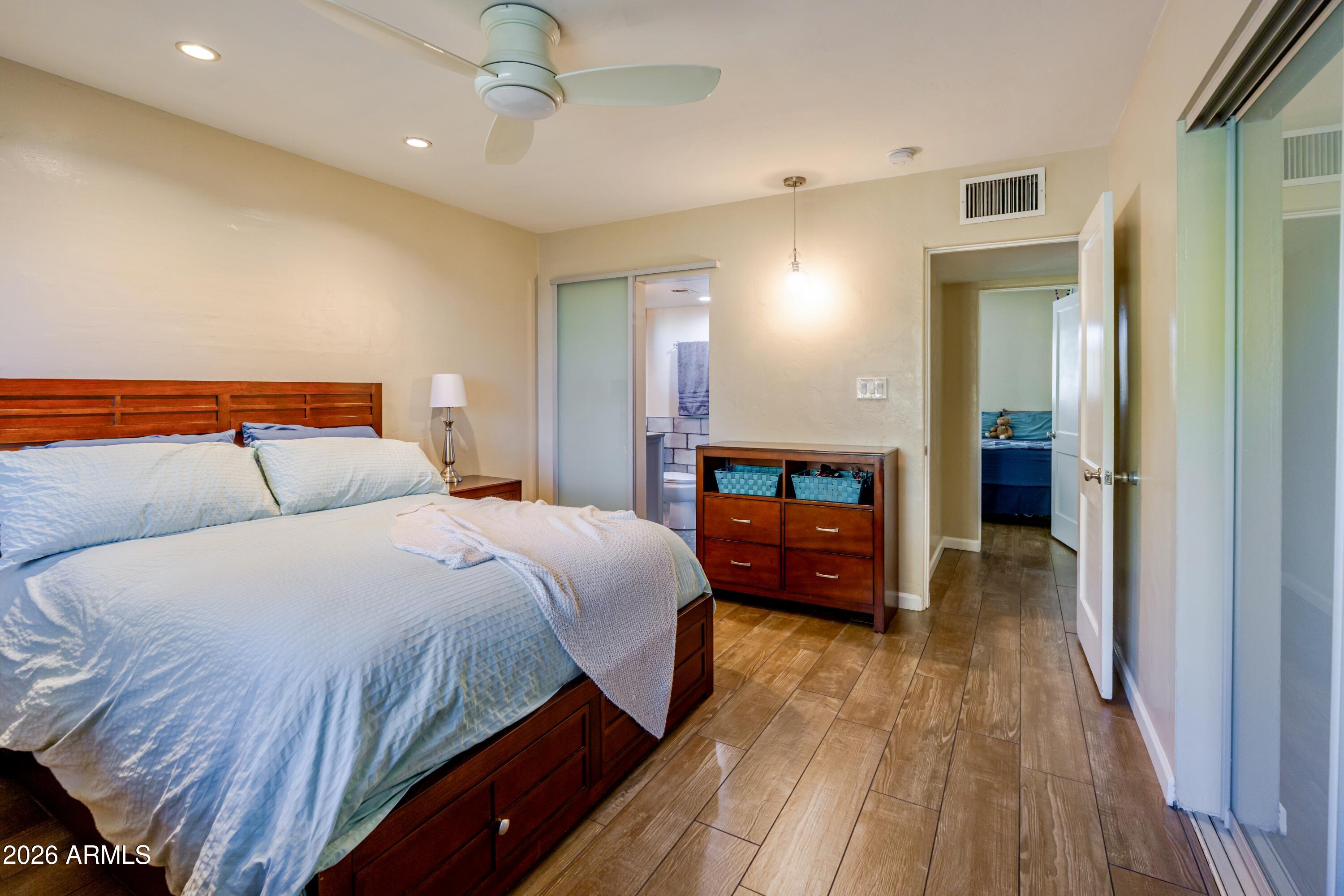 1631 West Rovey Avenue Phoenix, AZ 85015 - Photo 25 of 46 a bedroom with a bed and a chandelier