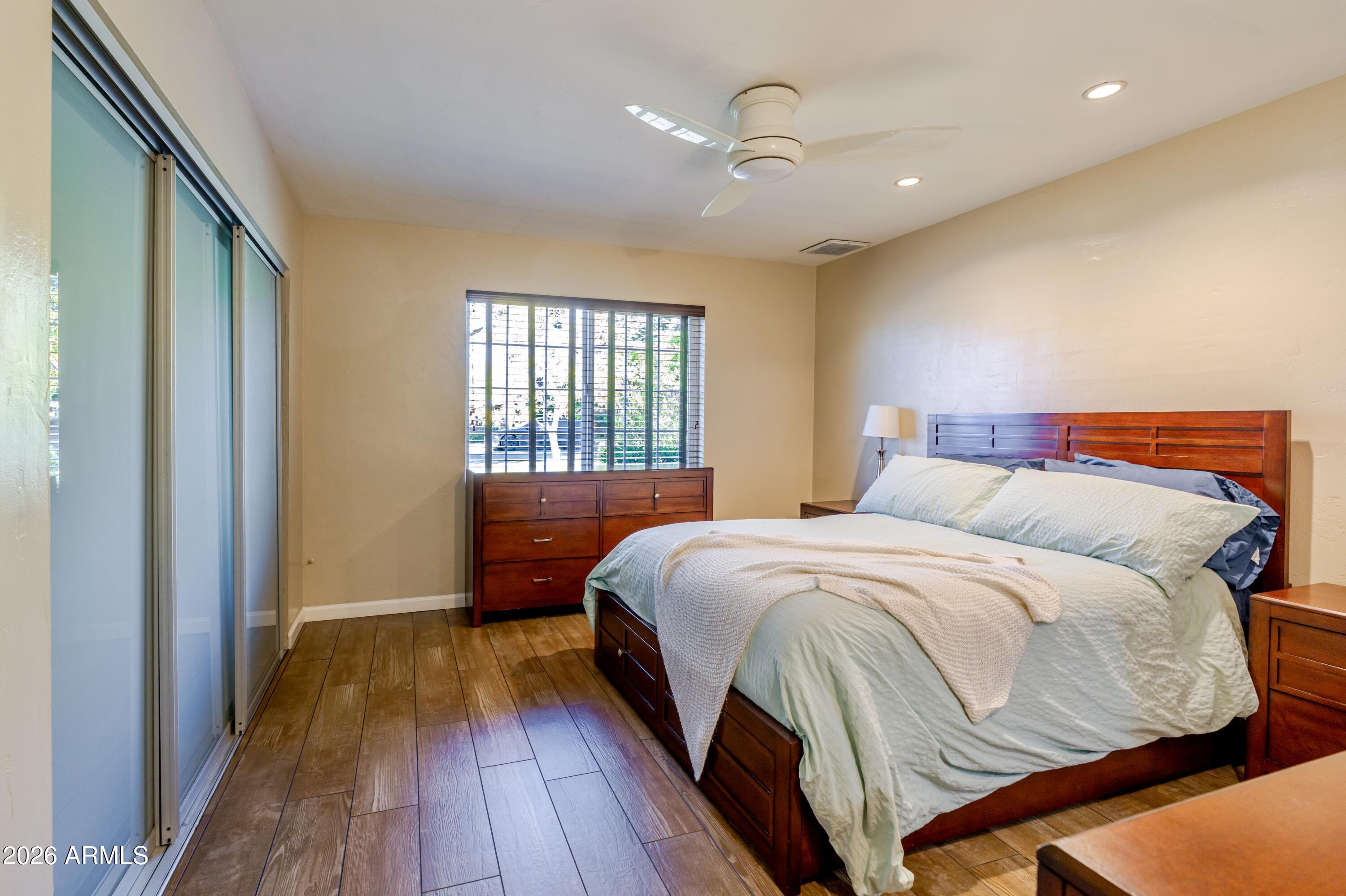1631 West Rovey Avenue Phoenix, AZ 85015 - Photo 26 of 46 a bedroom with a bed and wooden floor