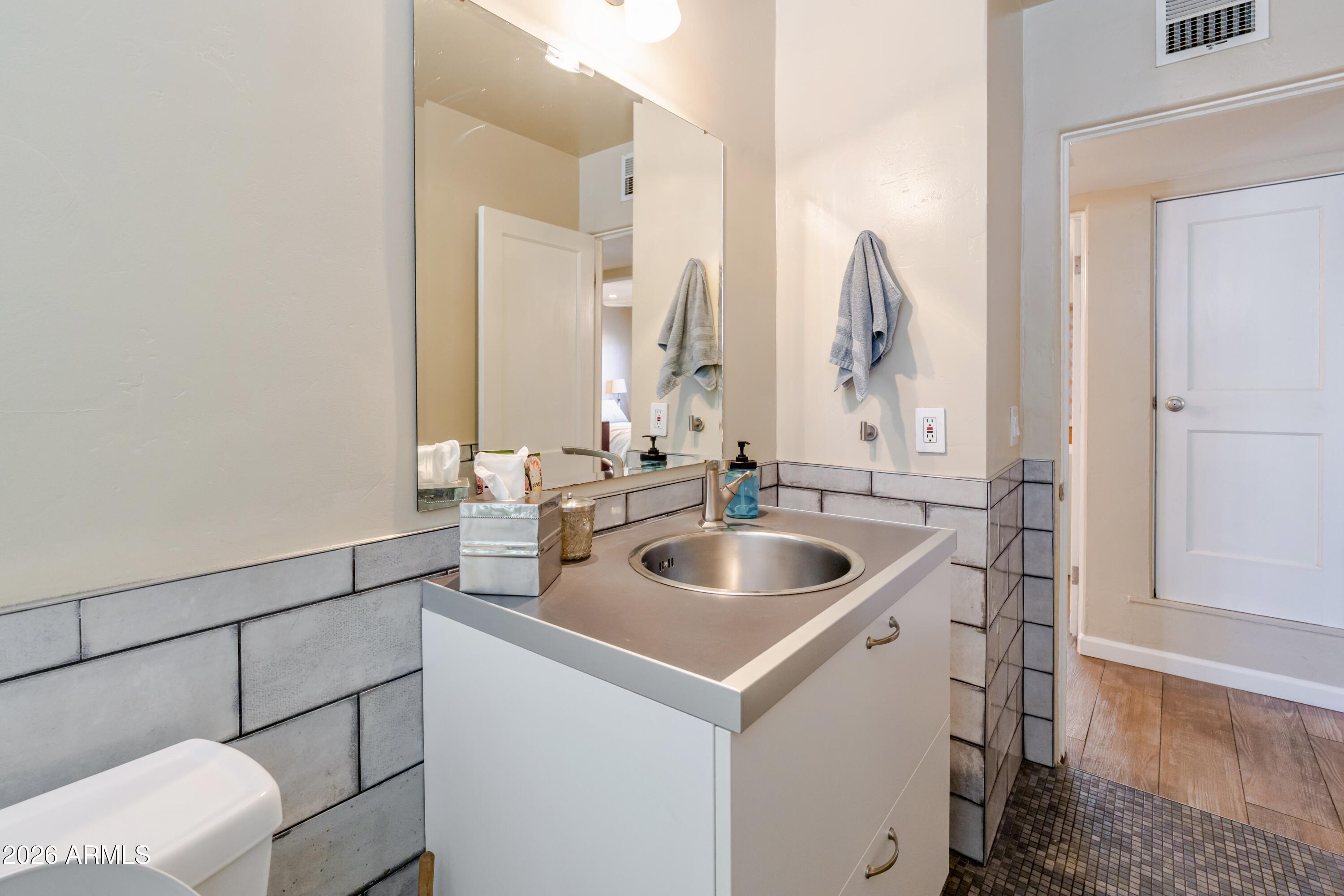1631 West Rovey Avenue Phoenix, AZ 85015 - Photo 29 of 46 a bathroom with a sink and a mirror