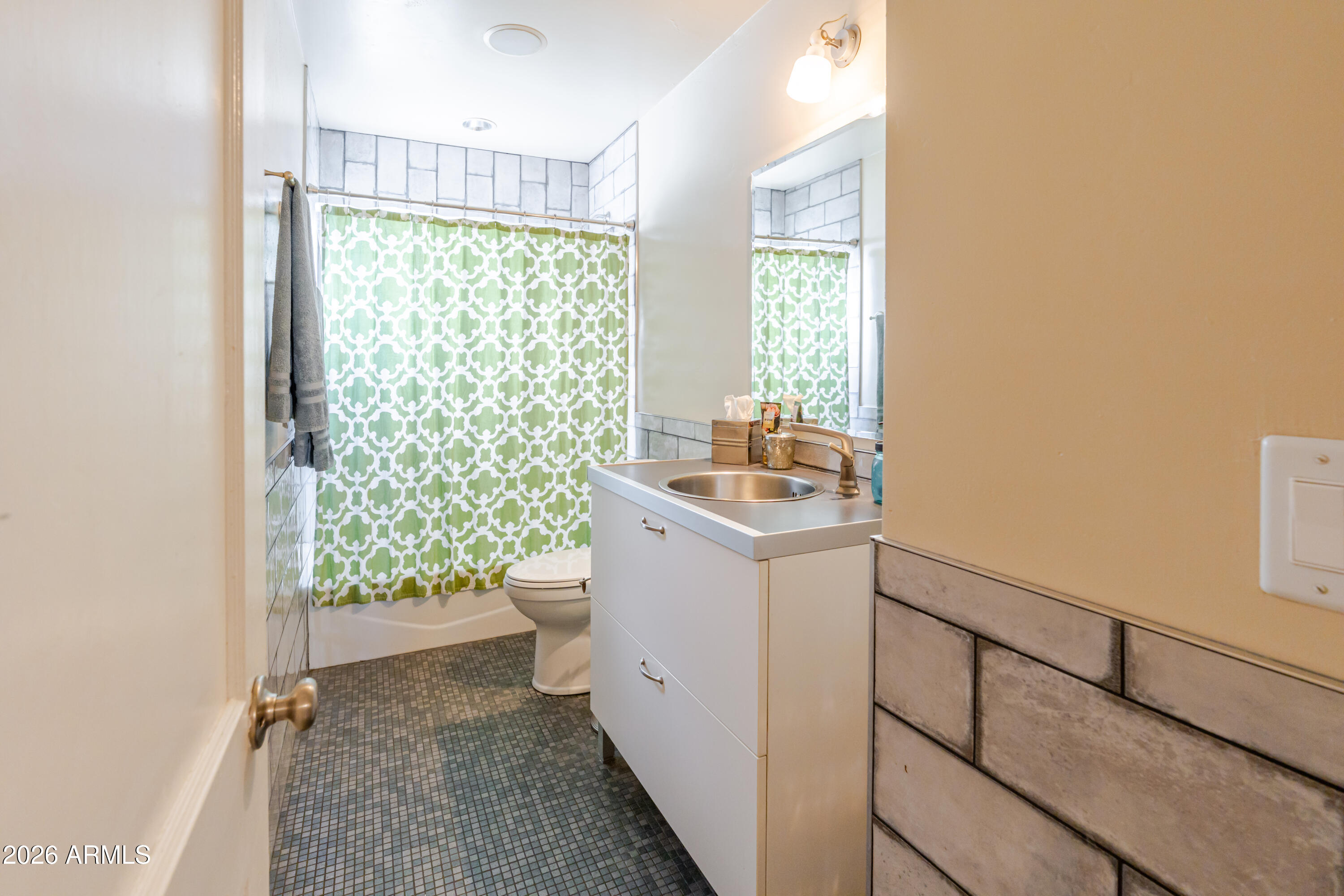 1631 West Rovey Avenue Phoenix, AZ 85015 - Photo 30 of 46 a bathroom with a granite countertop sink a toilet and a shower
