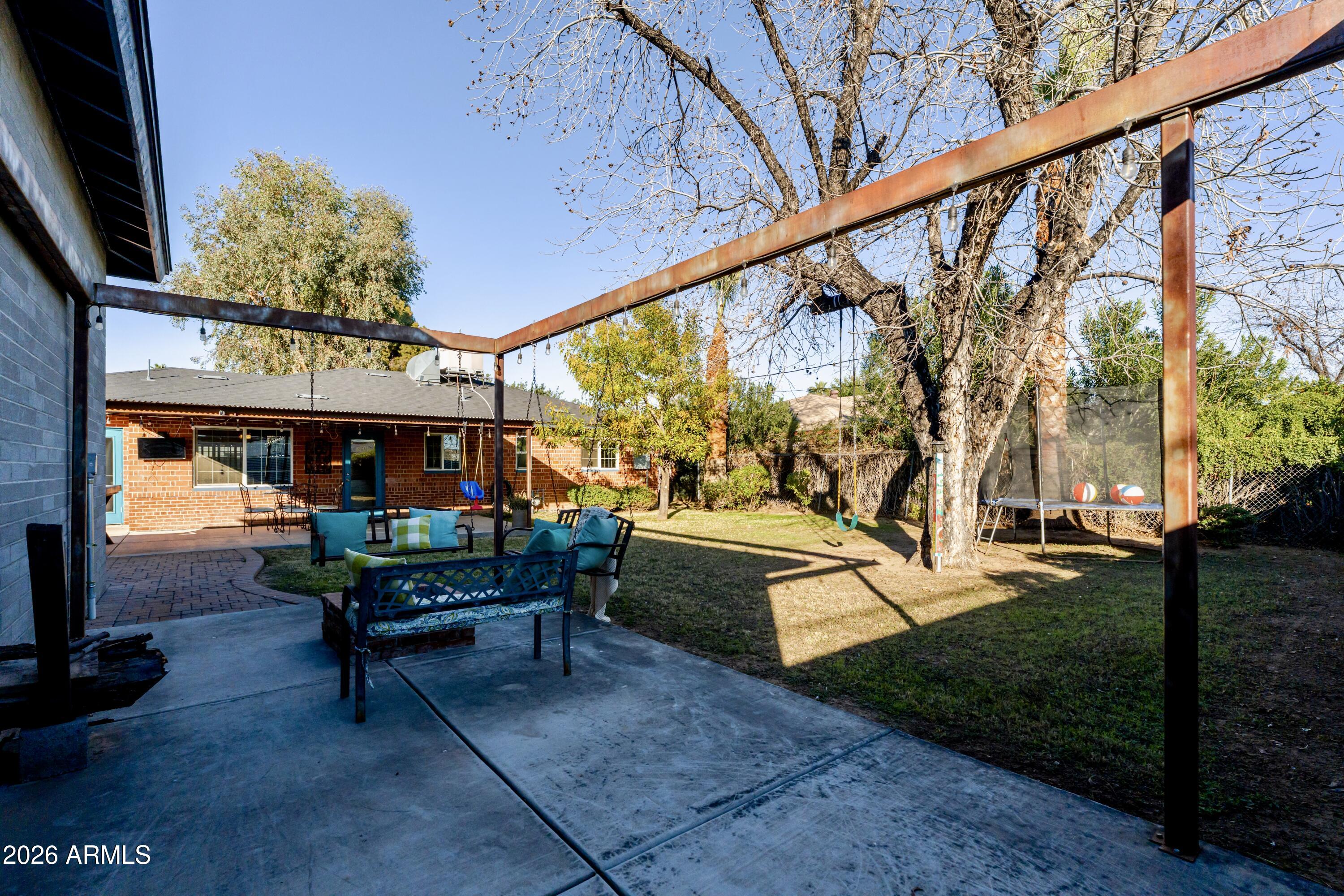 1631 West Rovey Avenue Phoenix, AZ 85015 - Photo 36 of 46 a view of patio with a table and chairs and potted plants