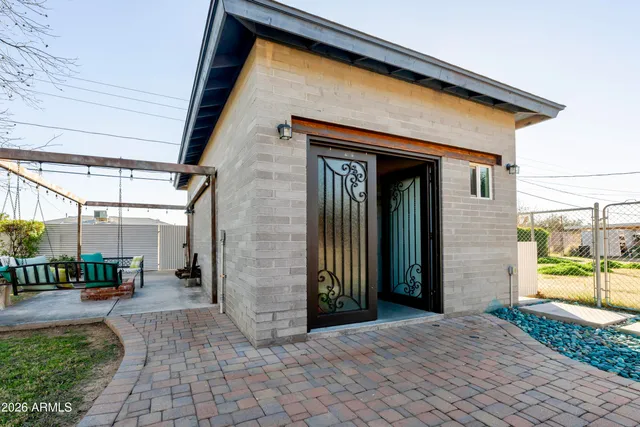 a view of a patio with table and chairs