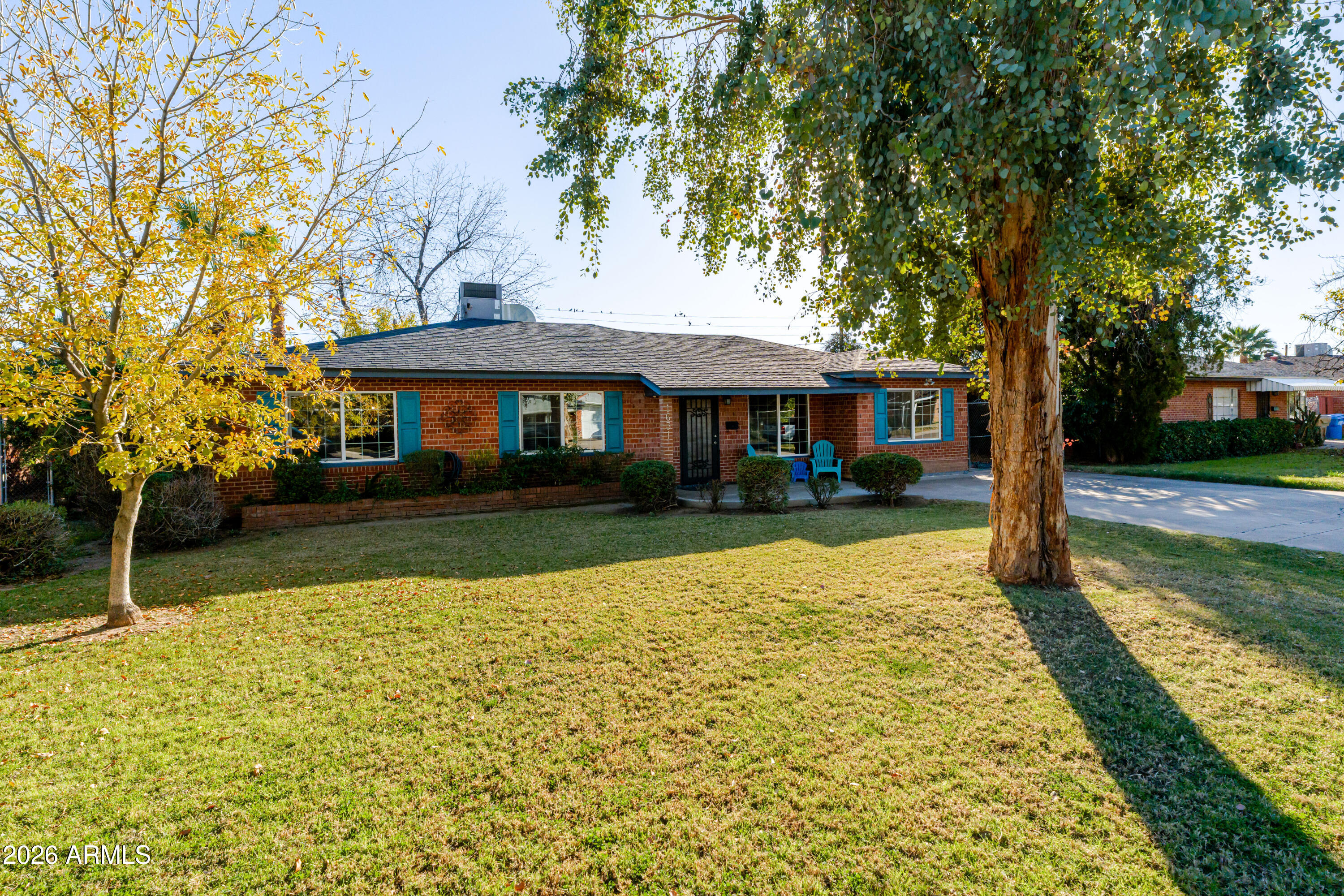 1631 West Rovey Avenue Phoenix, AZ 85015 - Photo 4 of 46 a front view of a house with a yard