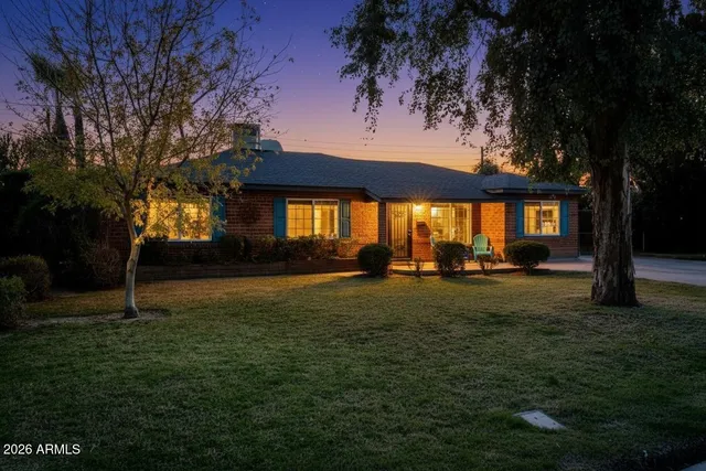 a backyard of a house with lots of green space table and chairs