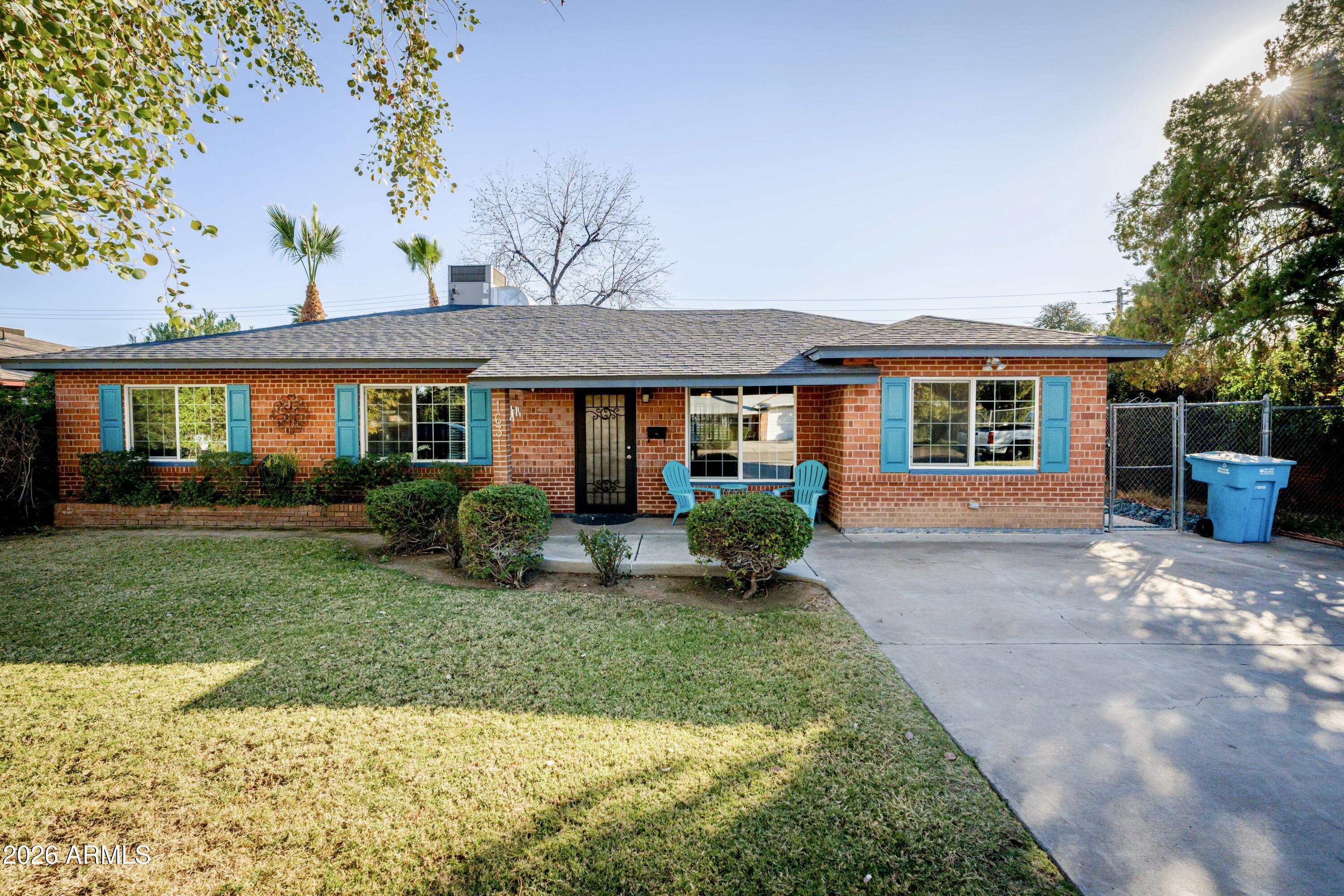 1631 West Rovey Avenue Phoenix, AZ 85015 - Photo 6 of 46 a front view of a house with a yard and potted plants