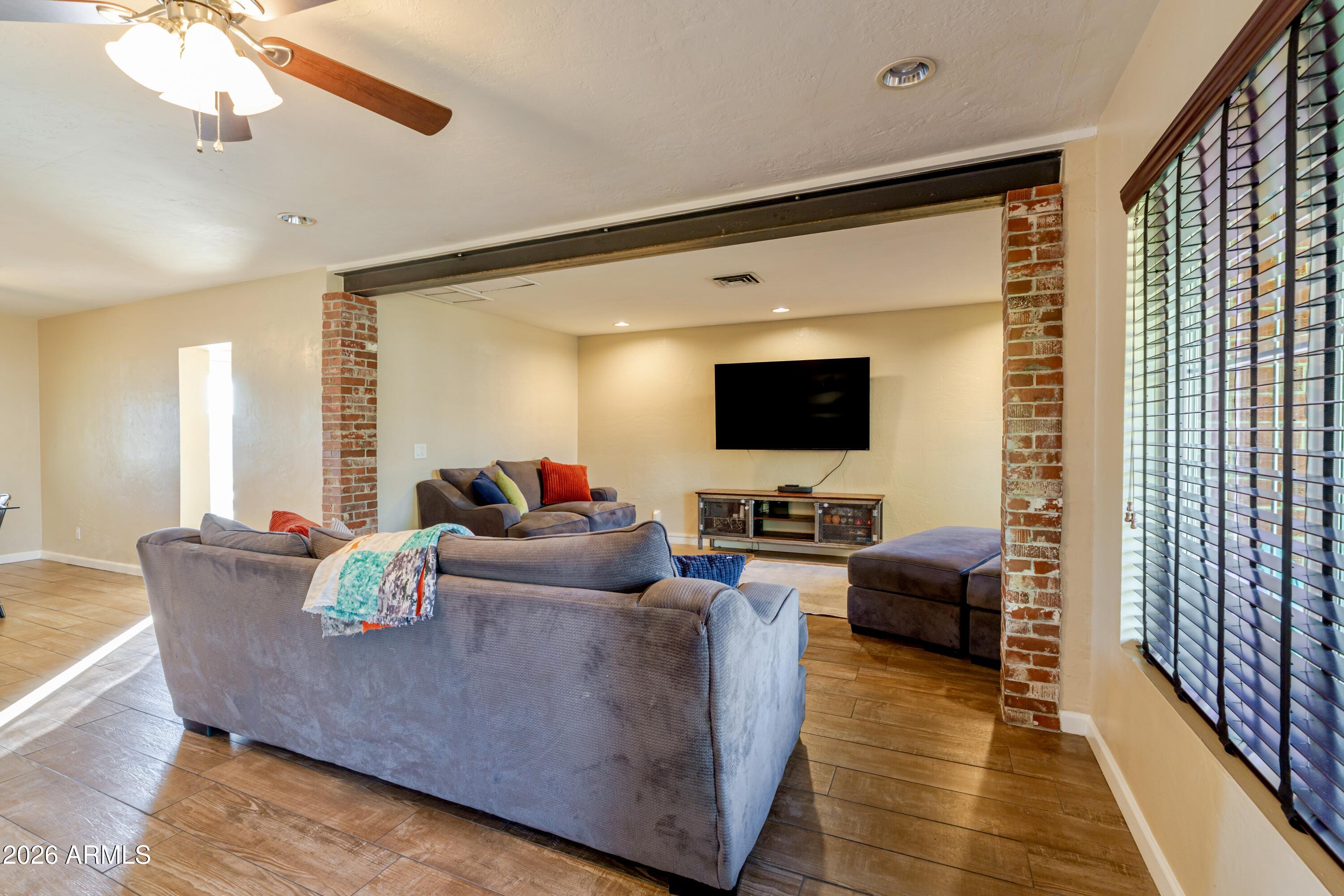 1631 West Rovey Avenue Phoenix, AZ 85015 - Photo 8 of 46 a living room with furniture and a flat screen tv