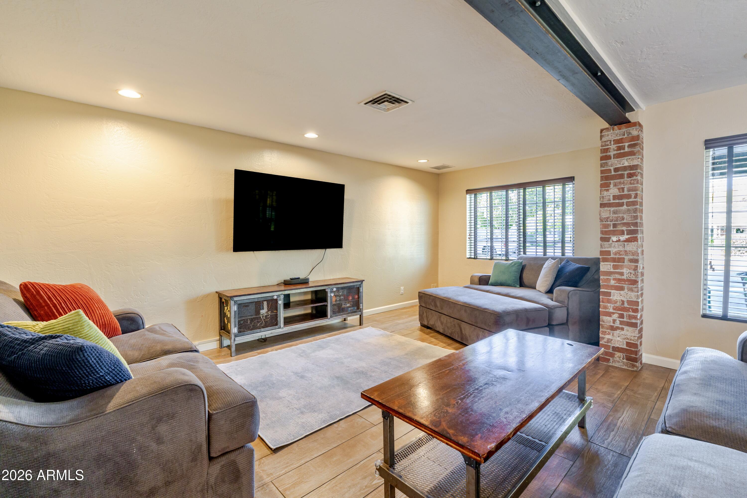 1631 West Rovey Avenue Phoenix, AZ 85015 - Photo 9 of 46 a living room with furniture and a flat screen tv
