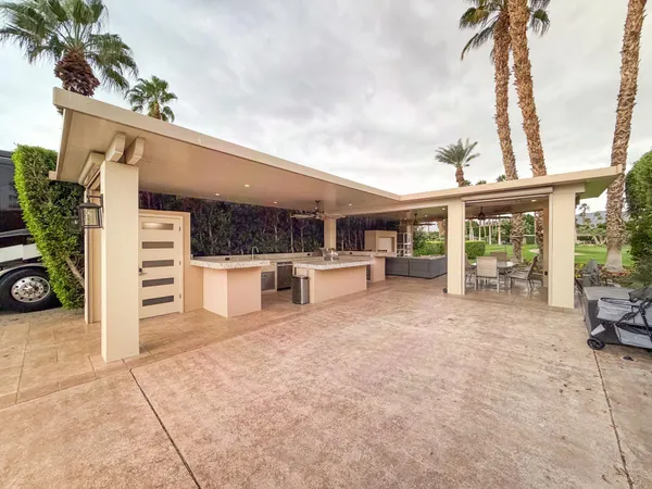 a view of a house with a porch and furniture