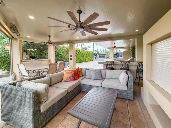 a kitchen with stainless steel appliances kitchen island granite countertop a stove a sink and a white counter space