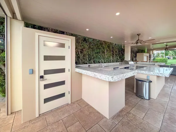 a large white kitchen with a large window