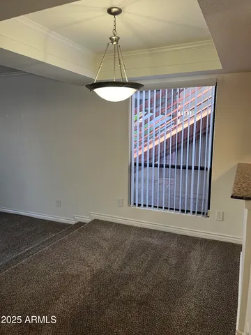 a view of a room with a ceiling fan and window