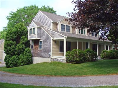 1 Piccadilly Road Sandwich, MA 02563 - Photo 2 of 13 a front view of a house with a yard