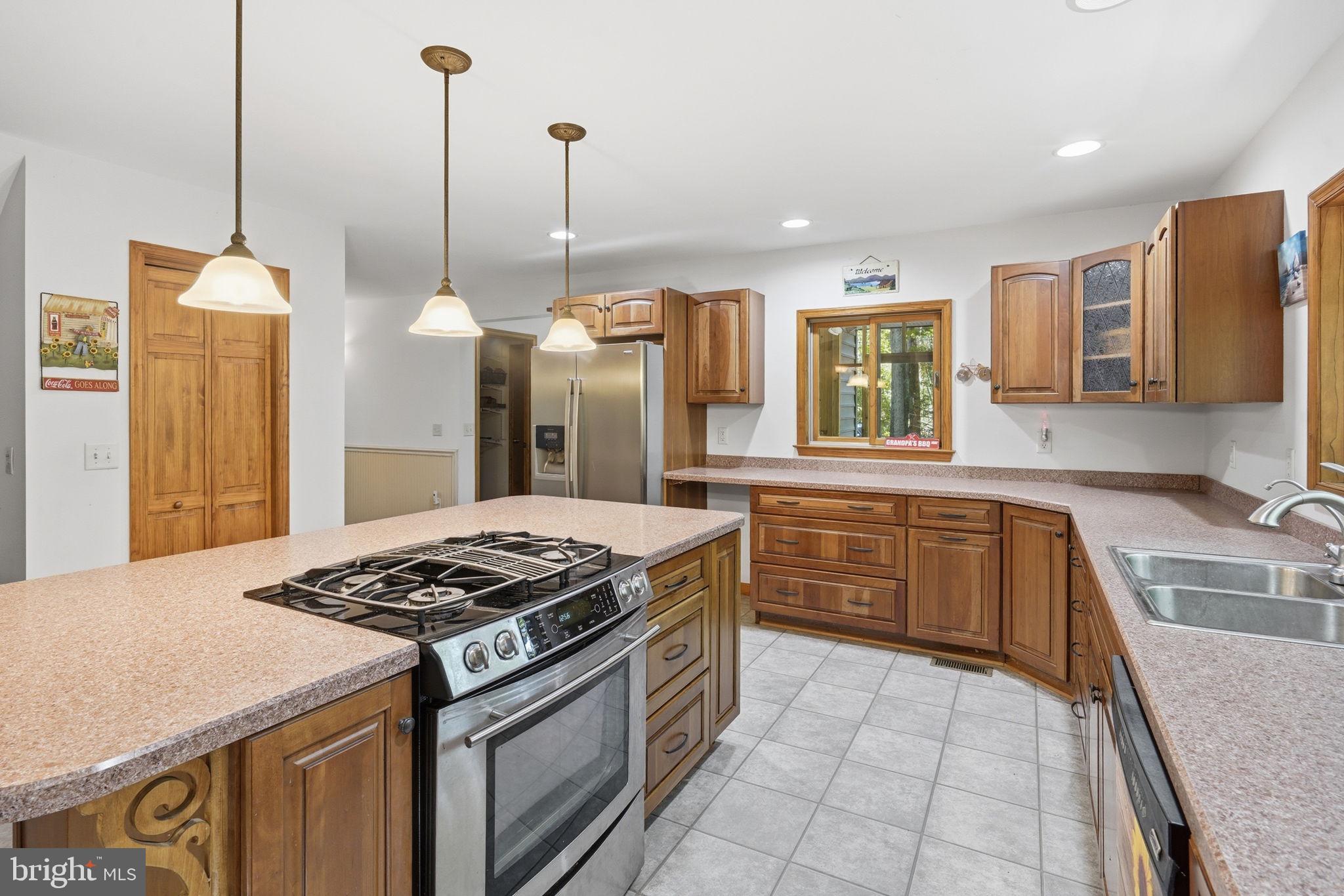 22300 Frazier Road Rock Hall, MD 21661 - Photo 5 of 38 a kitchen with stainless steel appliances granite countertop a stove a sink and a refrigerator