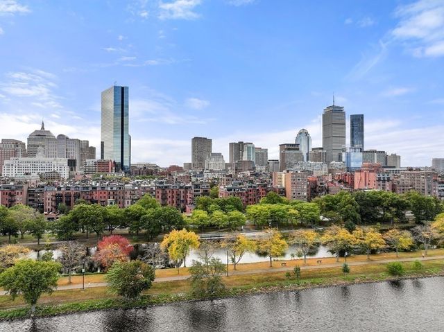 a view of a city with water and tall buildings in the background