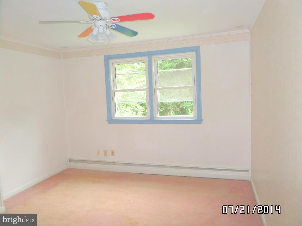 608 Cliveden Road Baltimore, MD 21208 - Photo 12 of 23 an empty room with a window and a ceiling fan
