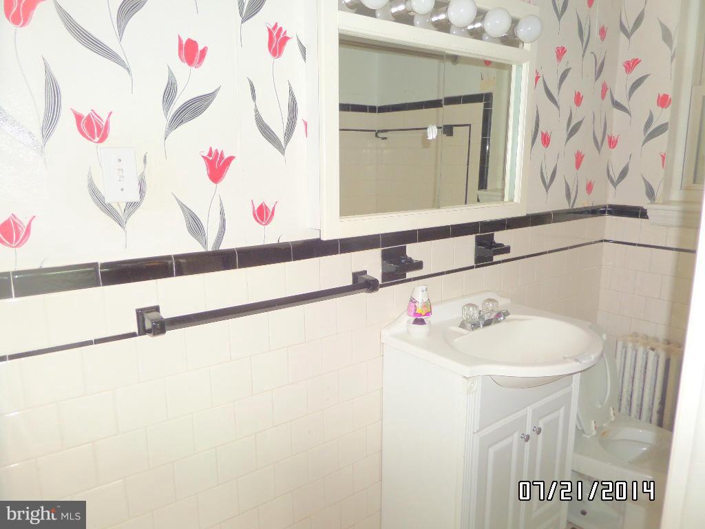 608 Cliveden Road Baltimore, MD 21208 - Photo 14 of 23 a bathroom with a sink and a mirror