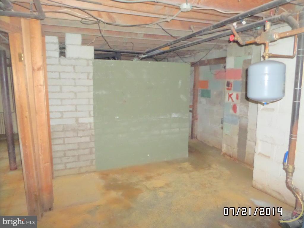608 Cliveden Road Baltimore, MD 21208 - Photo 20 of 23 a view of a room with a wooden table and chair