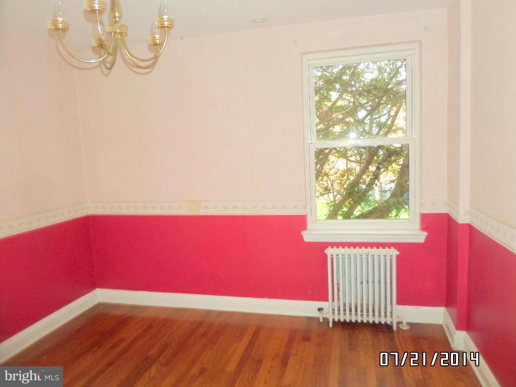608 Cliveden Road Baltimore, MD 21208 - Photo 4 of 23 a view of a room with wooden floor and windows