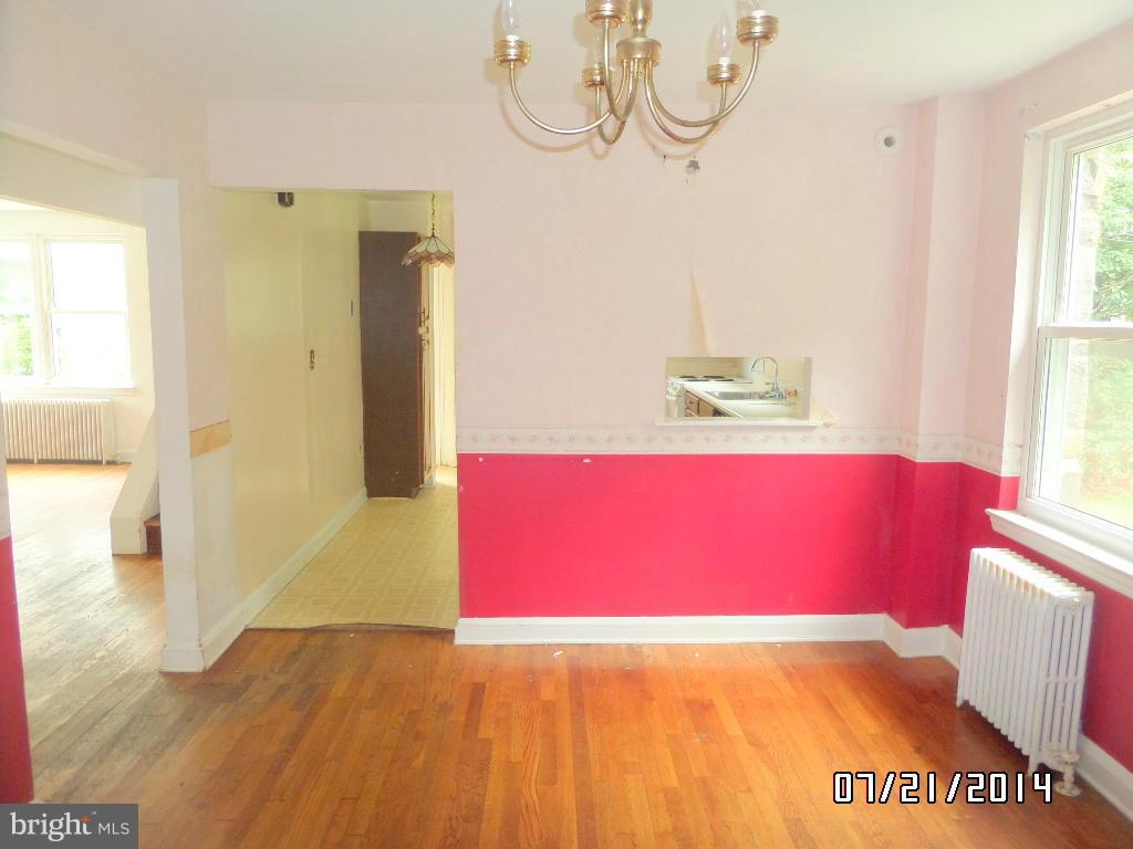 608 Cliveden Road Baltimore, MD 21208 - Photo 5 of 23 a view of empty room with wooden floor and window