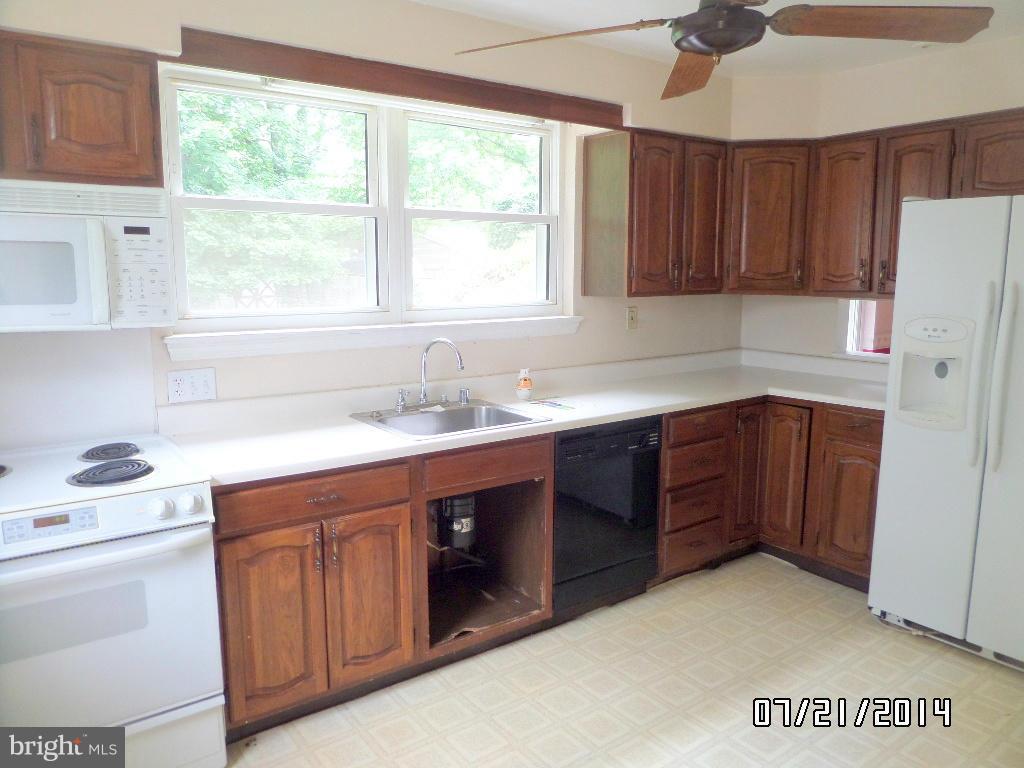 608 Cliveden Road Baltimore, MD 21208 - Photo 6 of 23 a kitchen with a sink cabinets appliances and a window