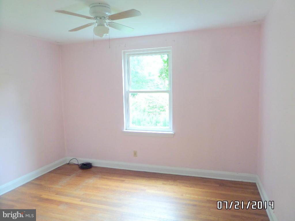 608 Cliveden Road Baltimore, MD 21208 - Photo 9 of 23 an empty room with a window and a fan