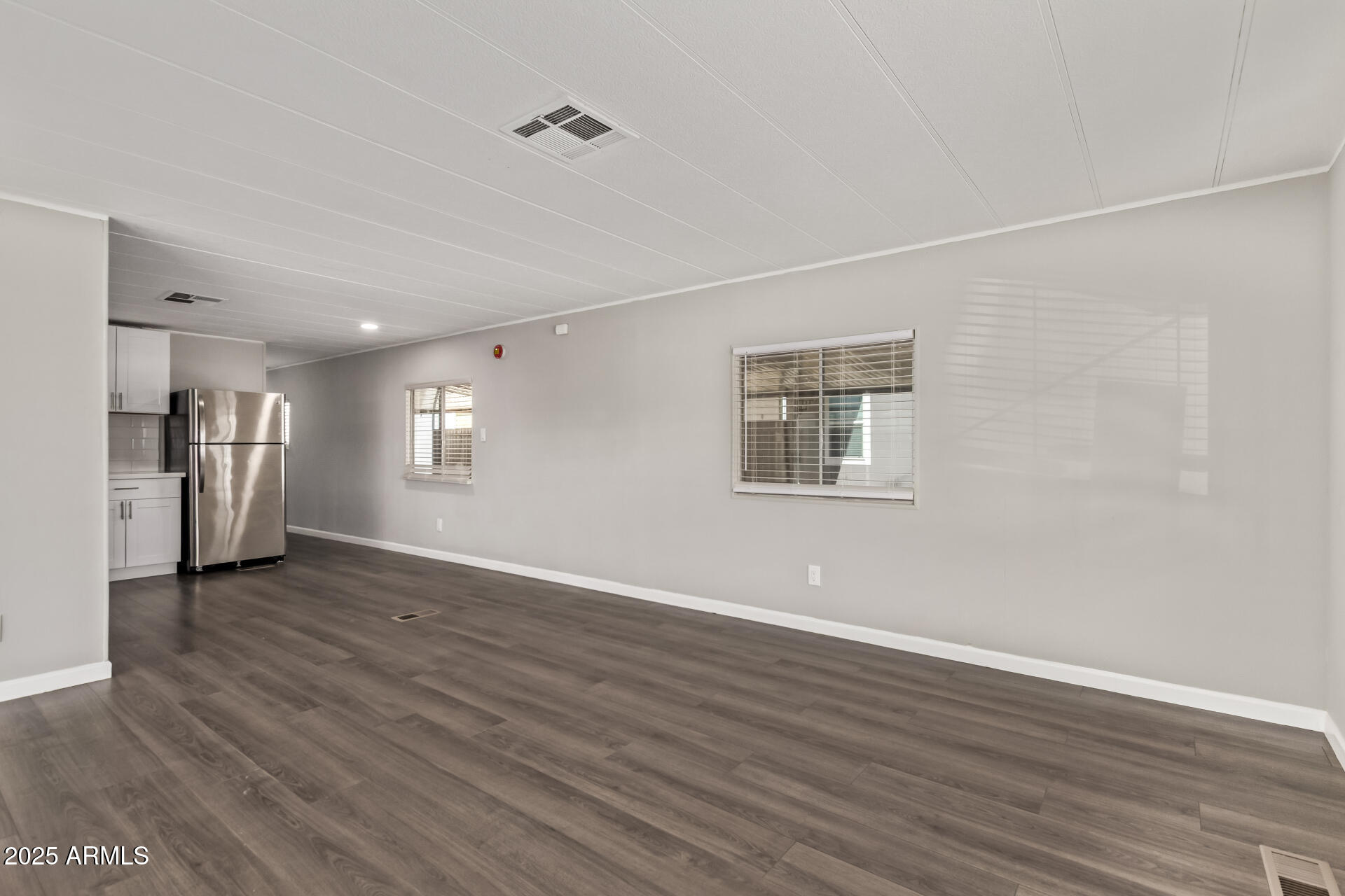 303 South Recker Road, Unit 200 Mesa, AZ 85206 - Photo 11 of 29 a view of a big room with wooden floor and a window