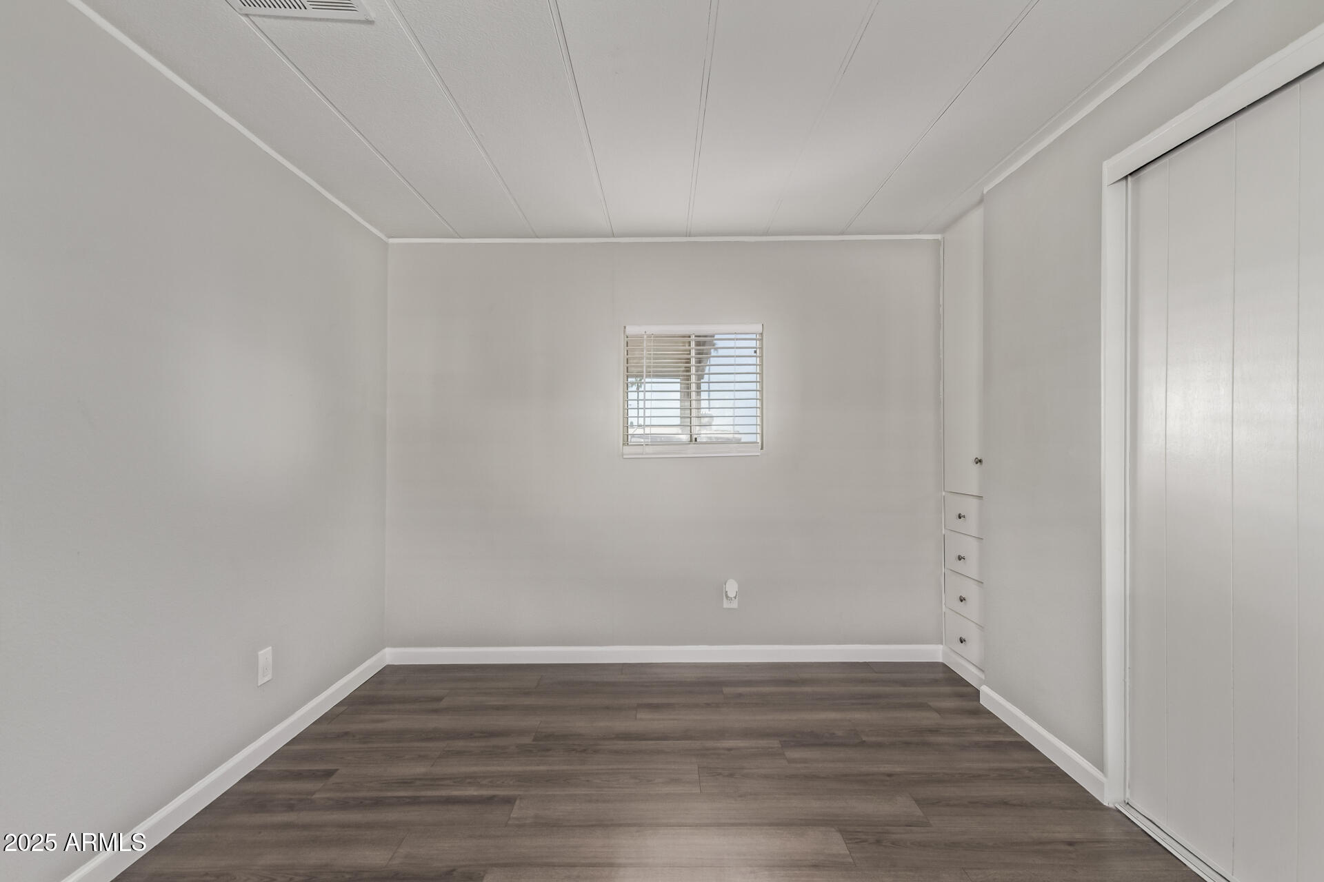 303 South Recker Road, Unit 200 Mesa, AZ 85206 - Photo 18 of 29 a view of an empty room with wooden floor and a window