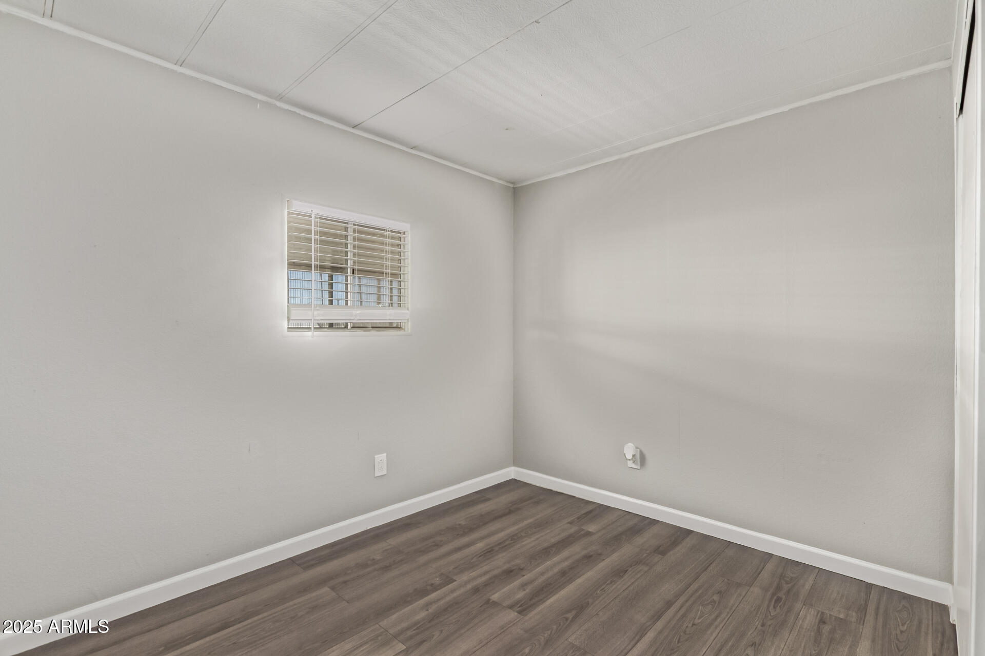 303 South Recker Road, Unit 200 Mesa, AZ 85206 - Photo 23 of 29 a view of an empty room with wooden floor and a window