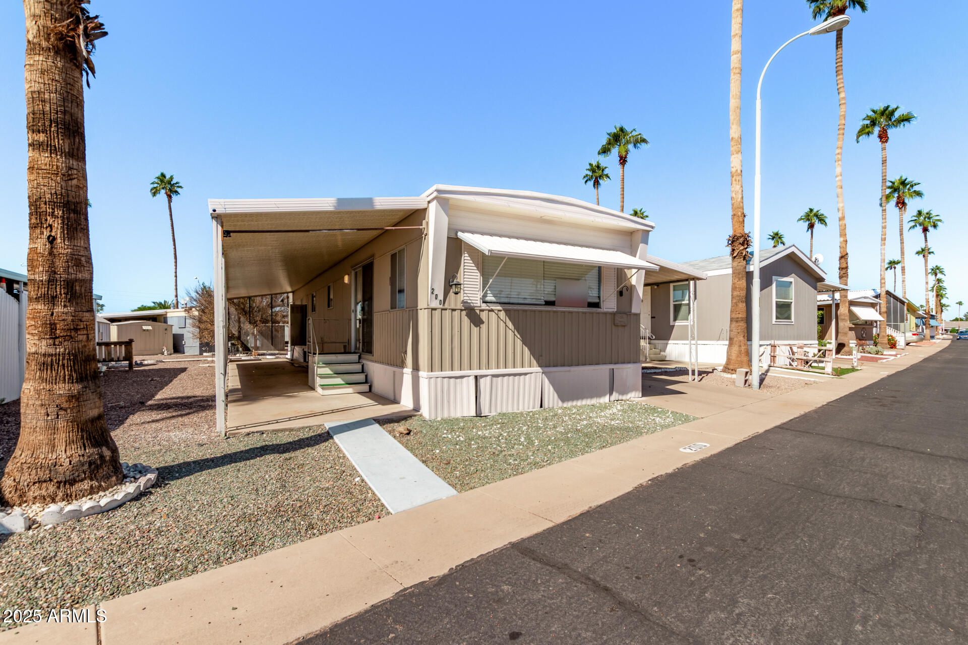 303 South Recker Road, Unit 200 Mesa, AZ 85206 - Photo 4 of 29 a view of a house with potted plants
