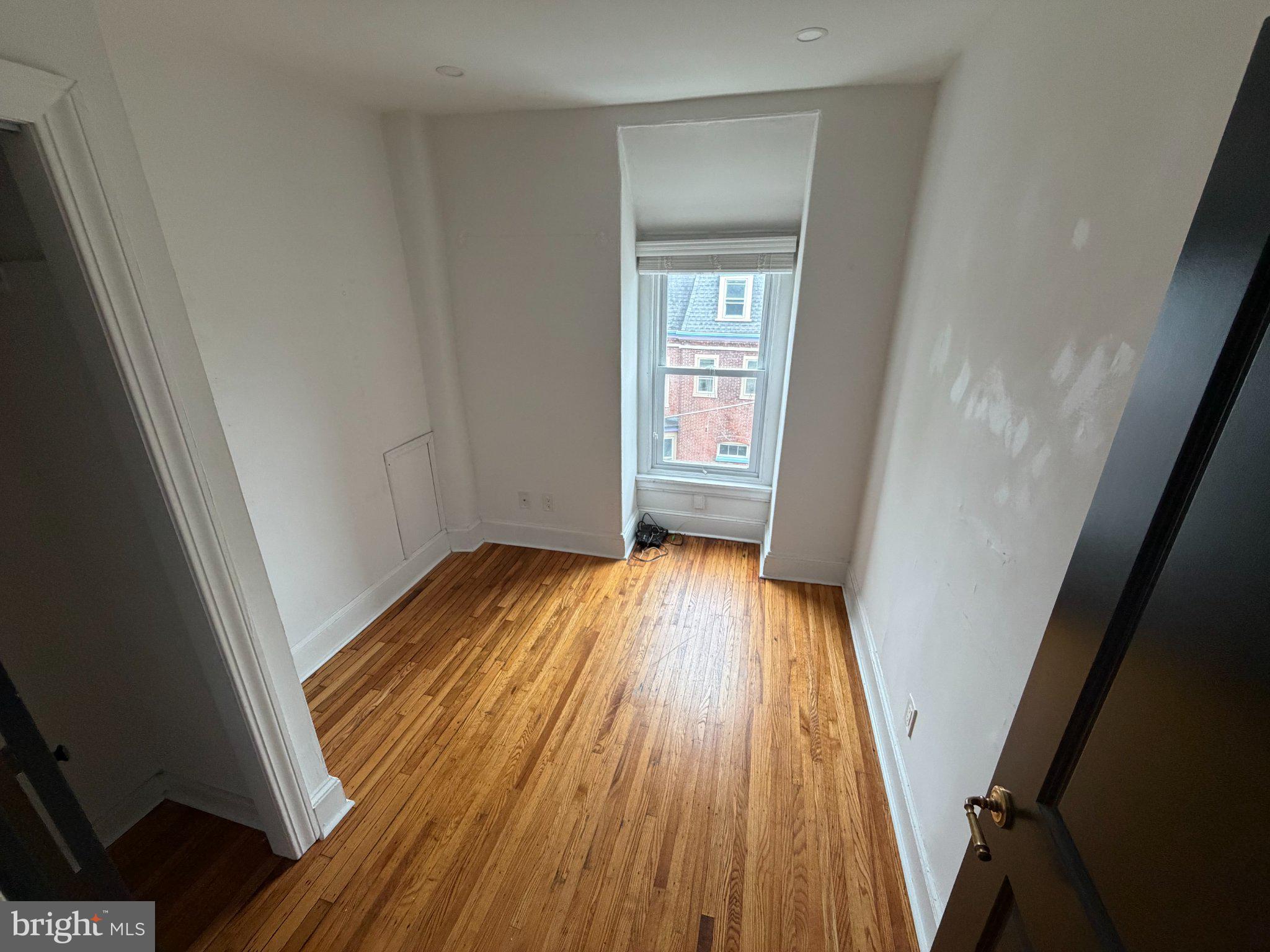 815 South 49th Street Philadelphia, PA 19143 - Photo 45 of 72 wooden floor in an empty room with a window