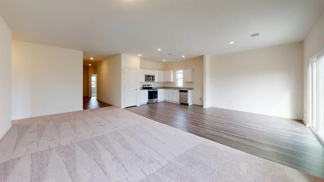 a view of kitchen and hall with wooden floor