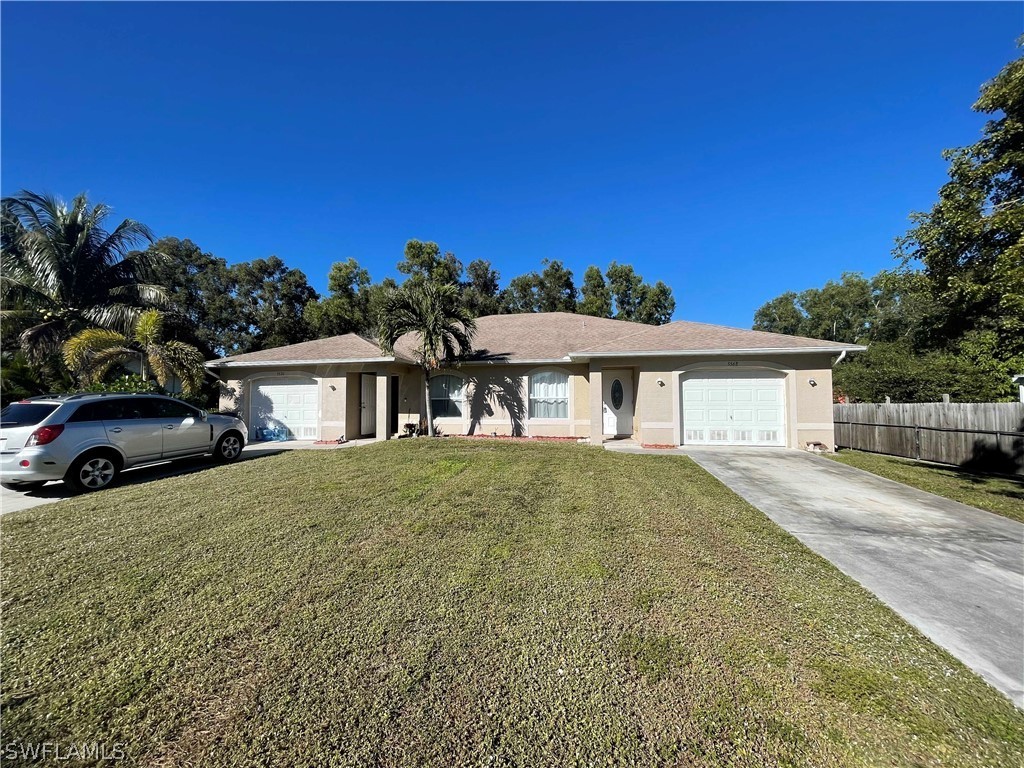 5568-5570 Judith Road Bokeelia, FL 33922 - Photo 1 of 22 a front view of a house with a yard and garage