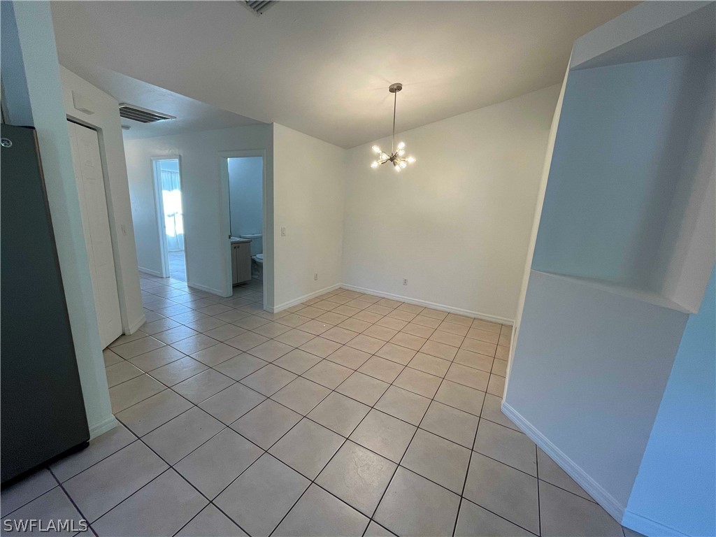 5568-5570 Judith Road Bokeelia, FL 33922 - Photo 5 of 22 an empty room with wooden floor and mirror