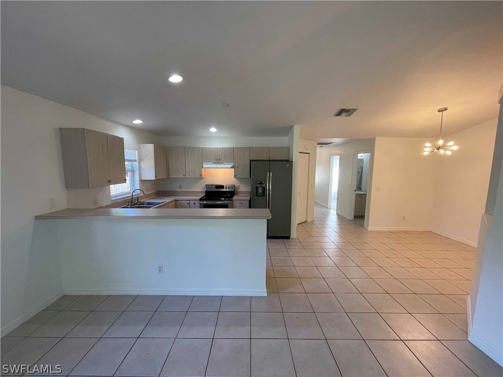 5568-5570 Judith Road Bokeelia, FL 33922 - Photo 8 of 22 a view of kitchen with granite countertop lots of white cabinets