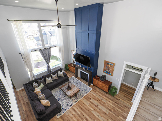 2487 Canyon Wild Road, Unit 413 Draper, UT 84020 - Photo 22 of 75 Living room with wood finished floors, recessed lighting, and a high ceiling